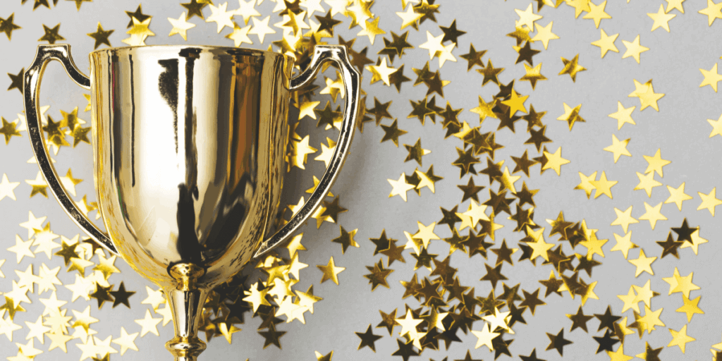 gold trophy with gold star confetti