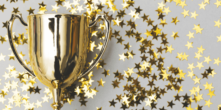gold trophy with gold star confetti